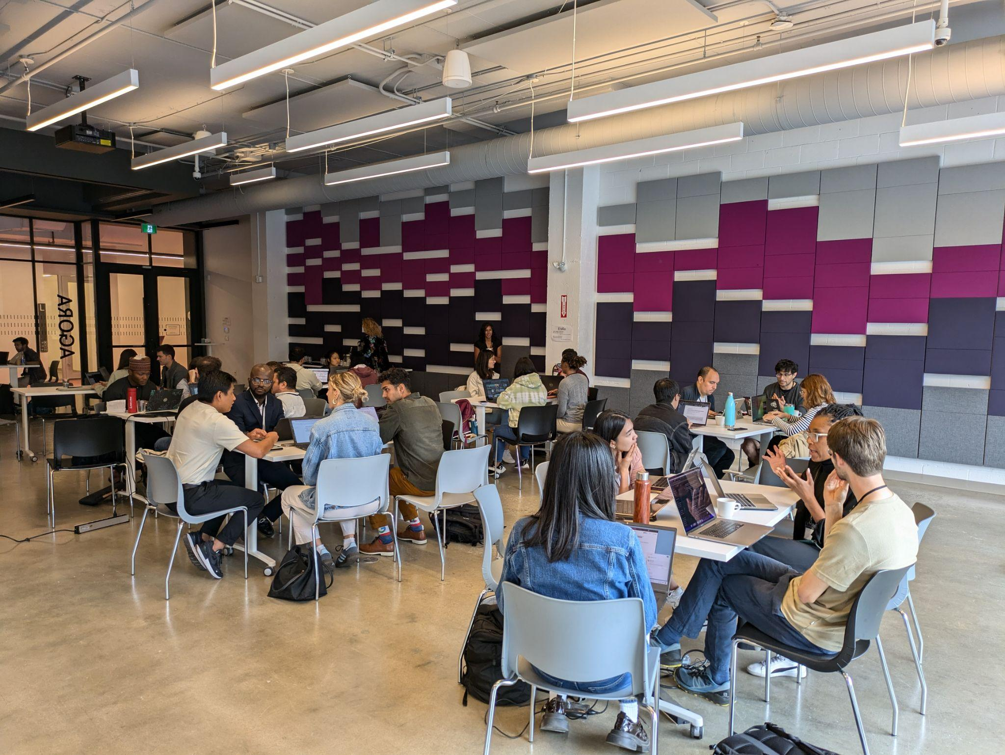 Participants work together in groups at Mila - Quebec AI Institute